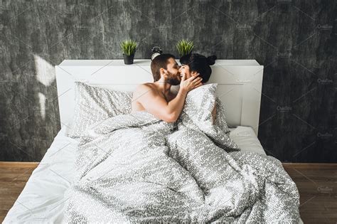 The Couple Is At Home In Bed High Quality People Images ~ Creative Market