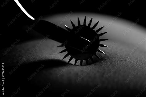 BDSM Nude Submissive Woman Act With Wartenberg Wheel Stock Photo