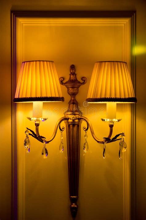 Electric Wall Lamp With Two Shades Hanging On A Stucco Wall Stock