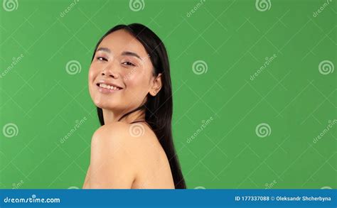 Women`s Beauty Portrait Of Young Smiling Asian Woman Isolated On Green Background Asian