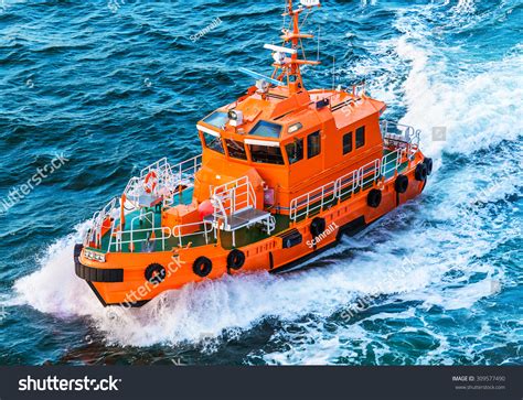 Orange Rescue Or Coast Guard Patrol Boat Industrial Vessel In Blue Sea