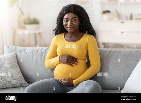 Beautiful Black Pregnant Woman Sitting On Couch At Home Stock Photo Alamy