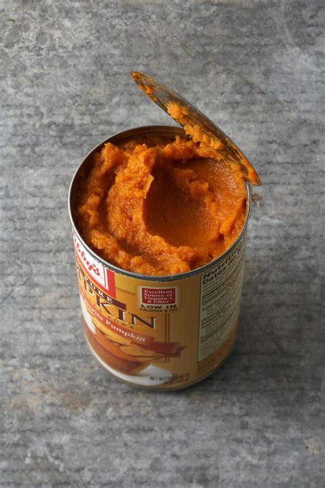A Can Of Mashed Sweet Potatoes With A Spoon Sticking Out Of The Top One