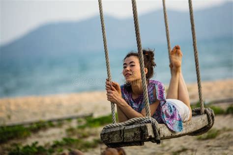 Young Woman Lies On The Swings On Sea Beach Stock Photo Image Of