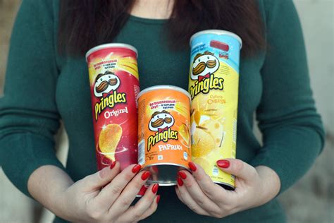 Young Girl Holds Few Pringles Potato Chips Cylinder Packs Pringles Is A Brand Of Potato Snack