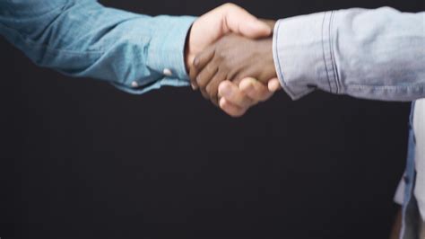 Hand Shaking Hands In White And Black Close Up Handshake Of African