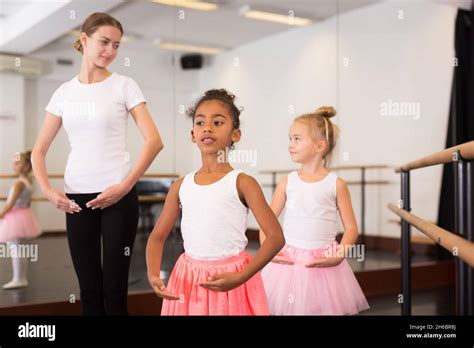 Dance Teacher Helping Her Little Girls Students Stock Photo Alamy