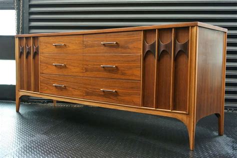 It is all wood, looks like walnut to me, has dovetail joints in the drawers. Kent Coffey Bedroom Set at 1stdibs