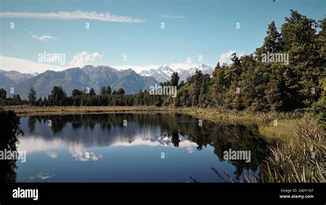 Lake Matheson Perfect Reflection Of Mountains In Waters Of Clear Lake