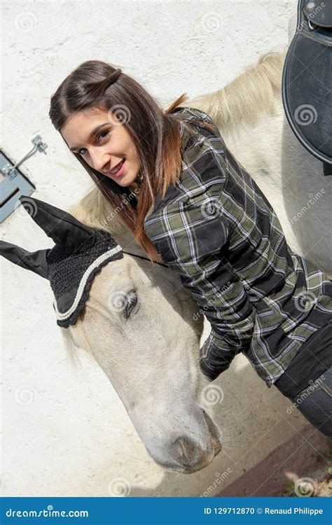 Portrait Of Beautiful Young Woman Rider With White Horse Stock Photo