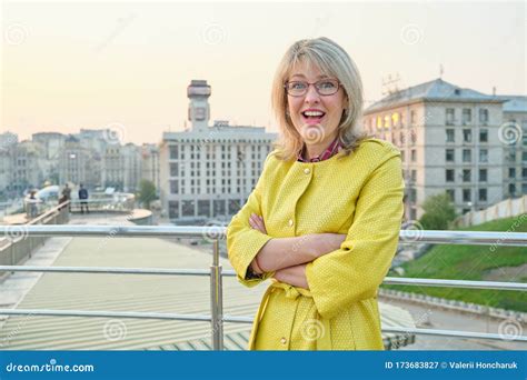 Outdoor Portrait Of Smiling Mature Woman With Folded Hands Stock Image