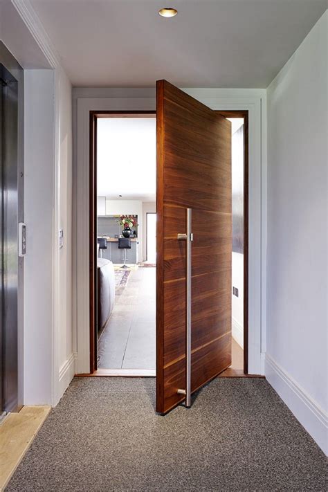 Your front door is considered the heart of your home. Internal Pivot Raw door in American Black Walnut with the ...