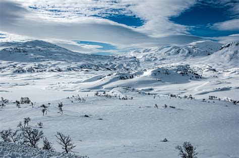 Online Crop Mountains Filled With Snow Under White And Blue Clear Sky