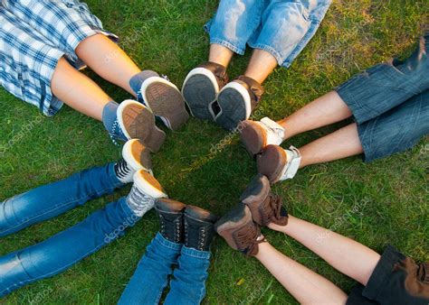 Teenage Friends Forming Circle With Their Legs Stock Photo Solidphotos