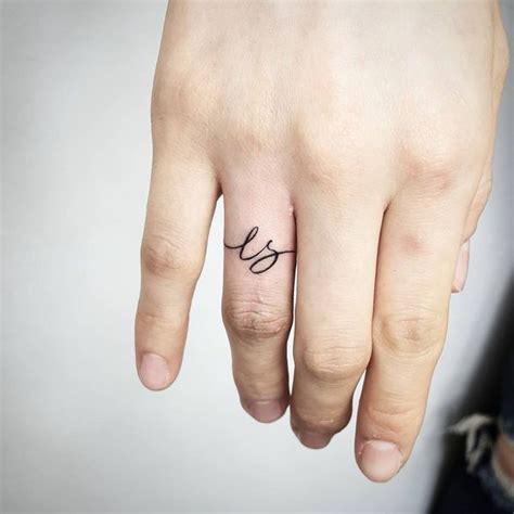 Ring tattoos are simple, but the cutest matching couples tattoos that remind couples of the bond they share. Finger Initial Tattoos for Ladies #weddingringtattoos ...