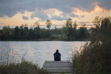 Sad Man Sitting By The Lake Stock Photos Pictures And Royalty Free