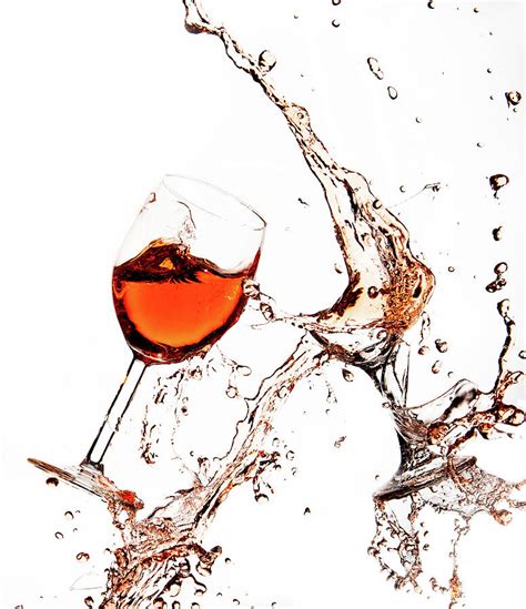 Broken Wine Glasses With Wine Splashes On A White Background Photograph