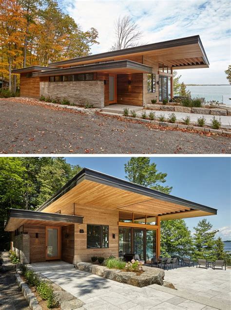 A Contemporary Cottage With A Cantilevered Roof Overlooks A Lake In
