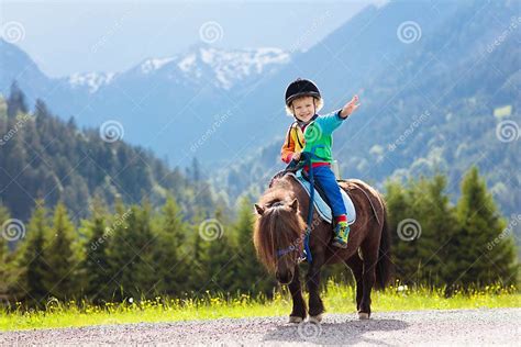 Kids Riding Pony Child On Horse In Alps Mountains Stock Image Image