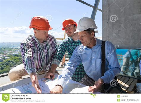 Team Of Builders Working With Blueprint On Site Architect Explain