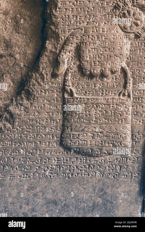 Ancient Assyrian Cuneiform Carved On Stone Wall Over Human Hand Relief