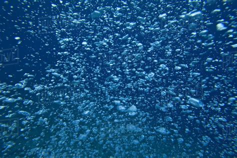 Underwater View Of Air Bubbles Rising Through Blue Ocean Water Stock