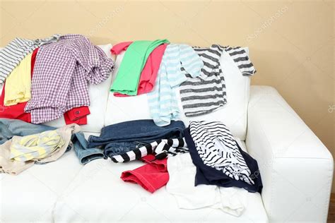 Messy Clothing On White Sofa Stock Photo By ©belchonock 63220473