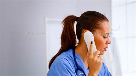 Medical Receptionist Answering Phone Calls From Patient Stock Photo By