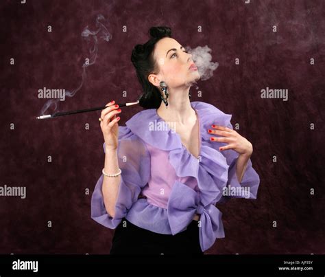 A Pin Up Girl In A Purple Blouse Holding A Cigarette Holder And Stock