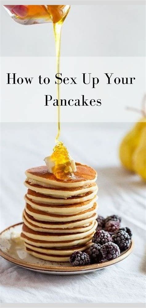 Pancakes On A Plate With Syrup Being Poured Over Them And Blueberries