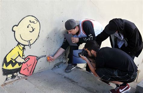 Oscar Nominated Graffiti Artist Banksy Spray Paints Hollywood Los Angeles