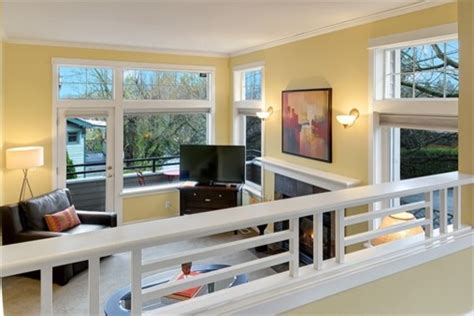 The narrow rail design minimizes the disruption of sightlines, so the staircase gallery wall is easily viewable from the living room below. Madison Park Staged Townhouse - Traditional - Living Room - Seattle - by Seattle Staged to Sell ...