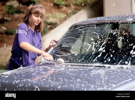 young white teen girl washing mother's mom car for a weekly allowance