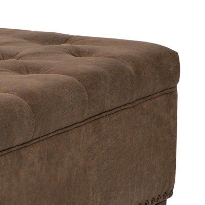A Large Brown Ottoman With Buttons On The Top And Bottom Sitting In