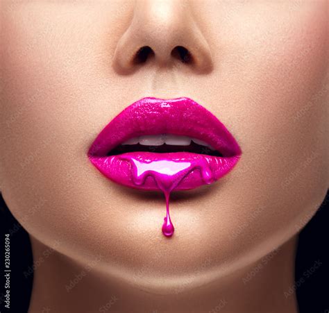 pink lipstick dripping lipgloss dripping from sexy lips purple liquid drops on beautiful model