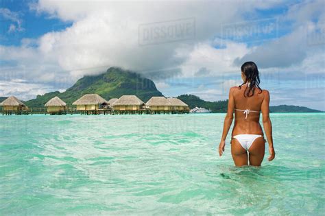 French Polynesia Tahiti Bora Bora Woman In The Ocean With Bungalows In The Background