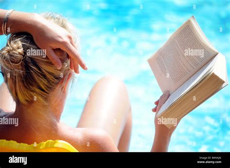 Relaxing Tanning By Swimming Pool In The Sunshine On Holiday Hi Res