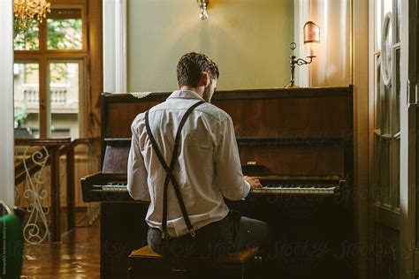 Back View Of A Man Playing Piano By Stocksy Contributor Aleksandra Jankovic Stocksy