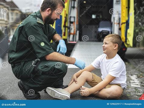 Injured Boy Getting Help From Paramedics Stock Image Image Of Ride