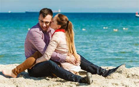 Couple Sitting On Beach Relaxing And Hugging Stock Image Image Of