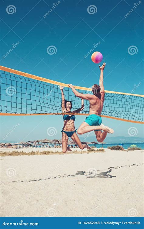 People Playing Beach Volleyball Having Fun In Sporty Active Lifestyle Man Hitting Volley Ball