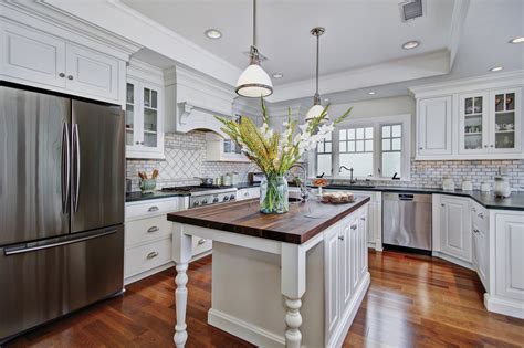 Beautiful wooden fireplace and stunning high ceilings. Colonial Coastal Kitchen | DeWils Custom Cabinetry