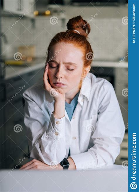 Close Up Portrait Of Tired Young Redhead Woman With Closed Eyes Sitting