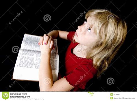Little Girl Praying Over Bible Stock Photography Image