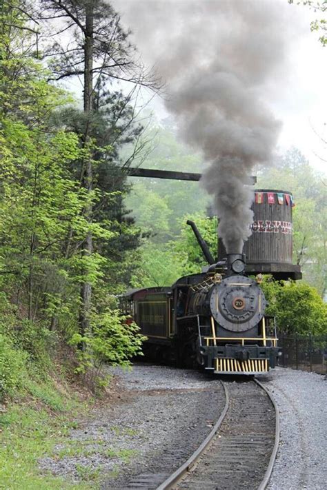 An Old Fashioned Steam Train Traveling Down The Tracks