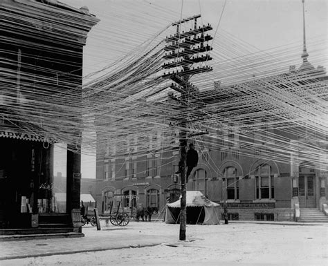 Unknown Photographer View Of A Lineman Working On Power Telephone