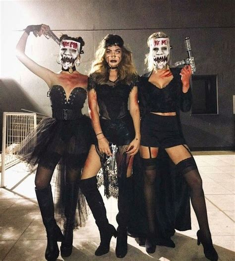 Three Women Dressed Up In Costumes Posing For A Photo With Skeleton Masks On Their Faces