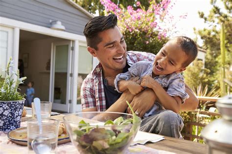 father and son eating outdoor meal in garden together stock image image of happy eating 85177427