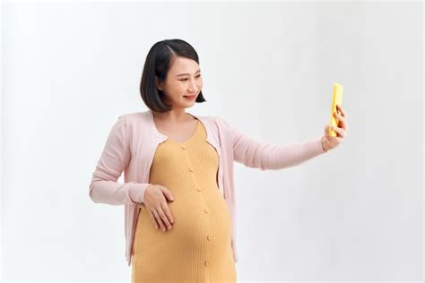 premium photo happy pregnant woman with smartphone having video call over white