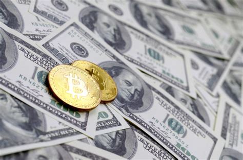 The current bitcoin value is shown in usd, eur and gbp on top of the chart. Premium Photo | Golden bitcoins lie on a lot of dollar ...